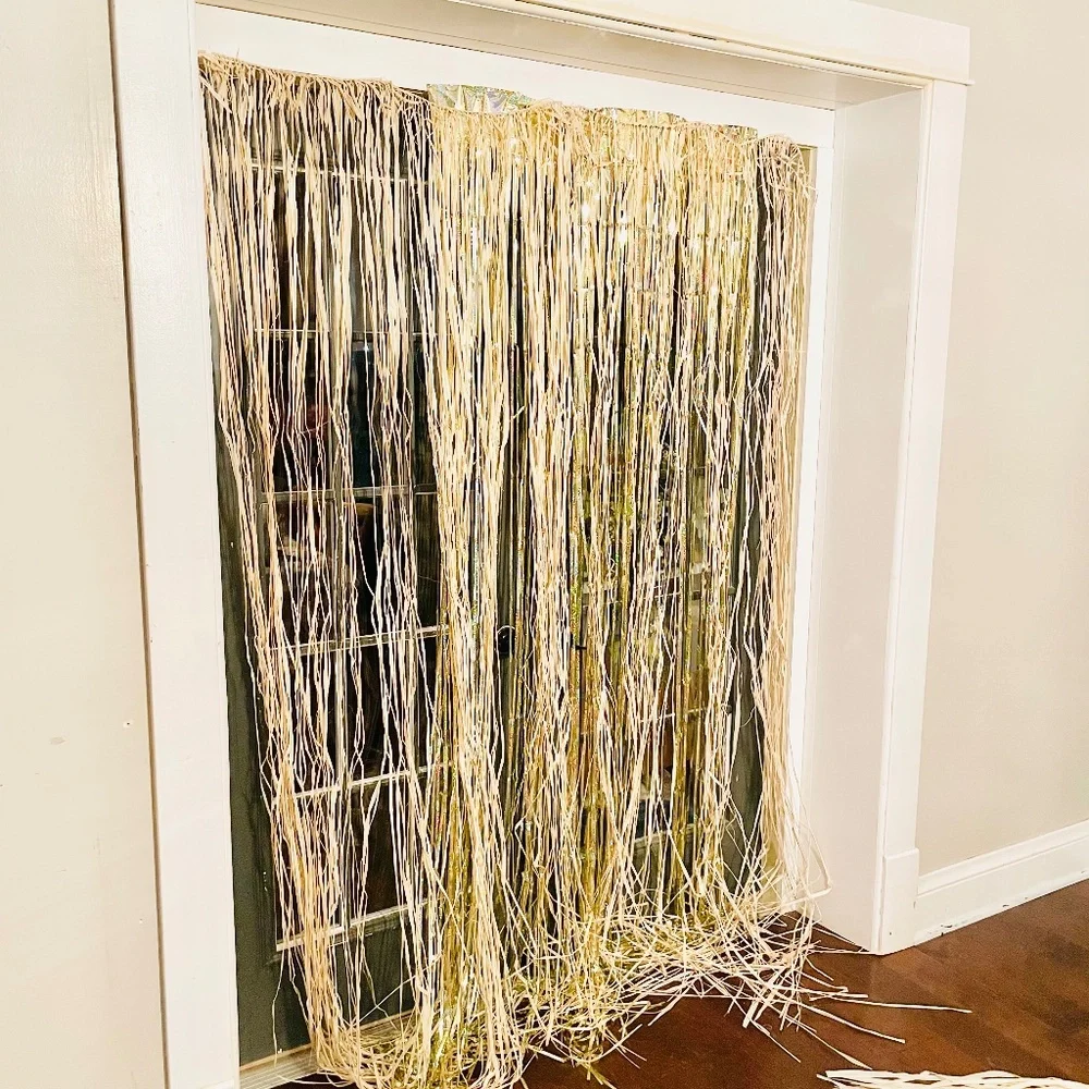 Natural grass straw and gold iridescent sparkling door decor and palm leaves